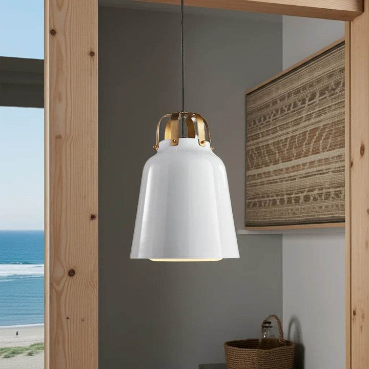 White and brass pendant light over modern entryway console – beach-style setting

