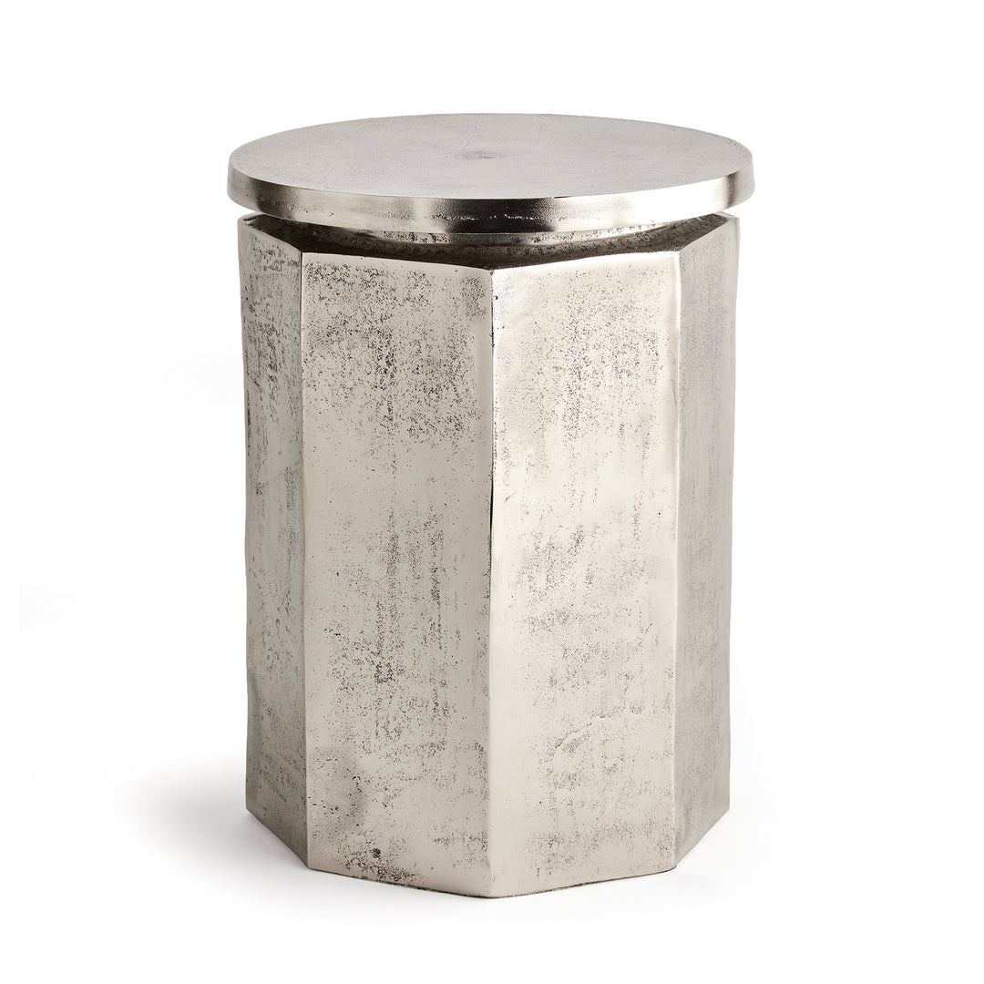 Angled side view of hexagon industrial stool with sculpted profile and metallic tone
