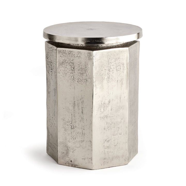 Angled side view of hexagon industrial stool with sculpted profile and metallic tone
