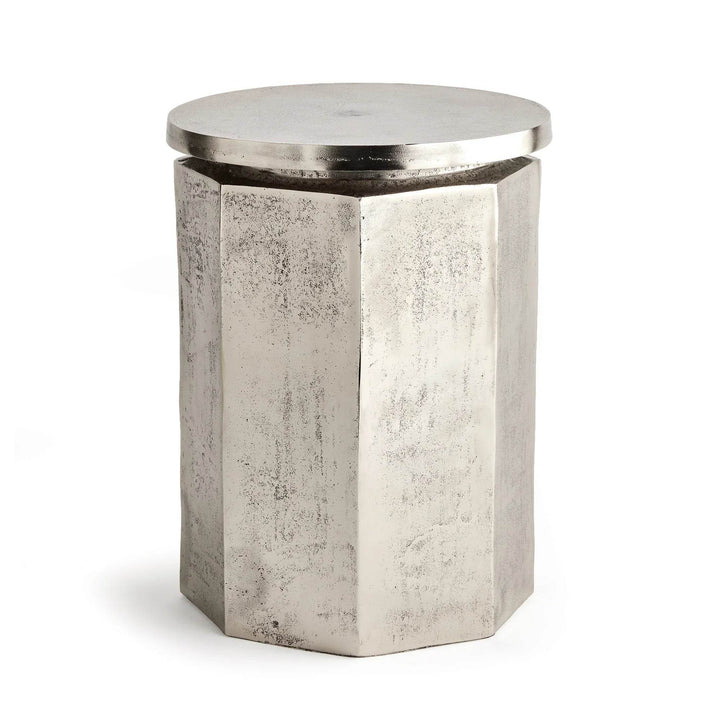 Angled side view of hexagon industrial stool with sculpted profile and metallic tone
