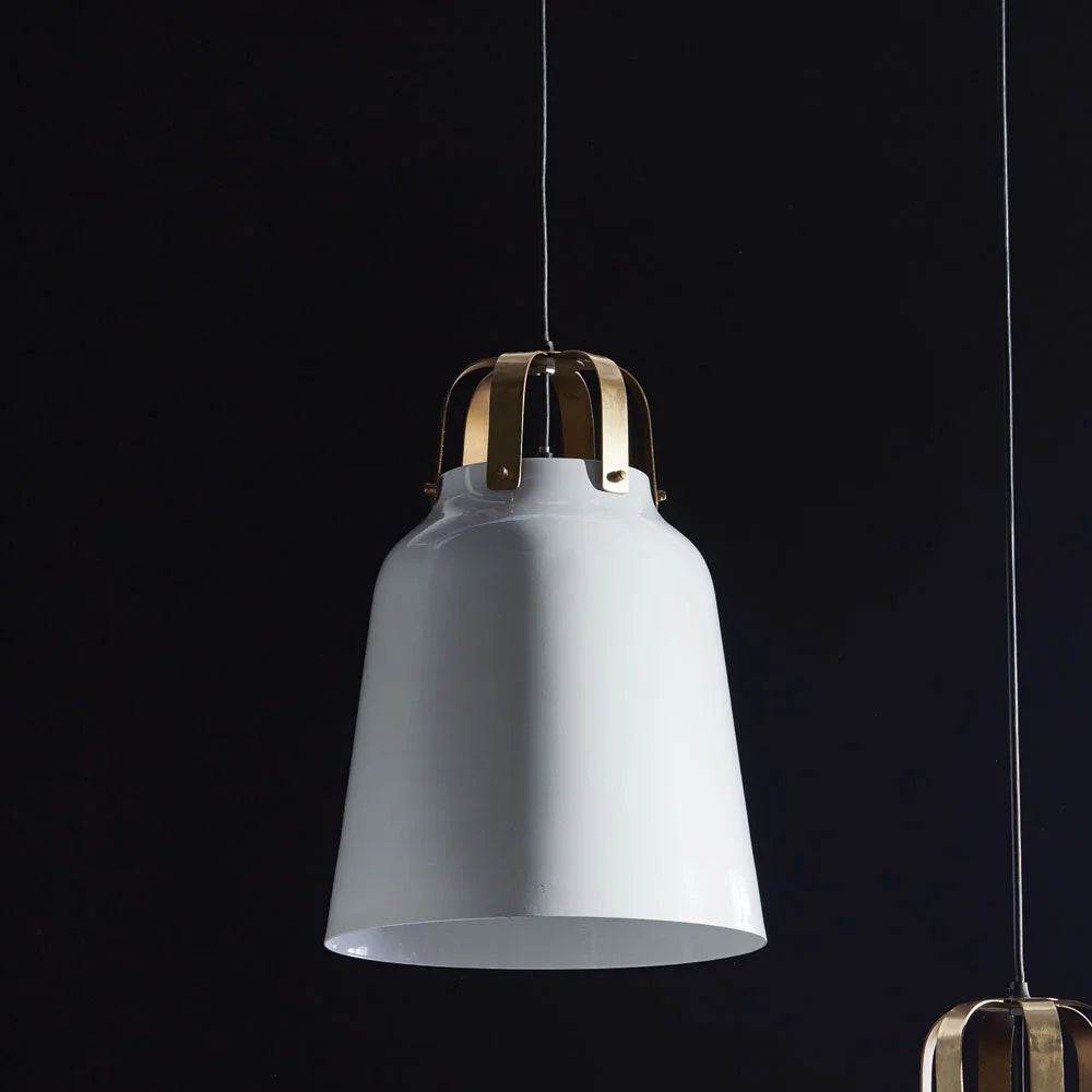 Close-up of brass mount on modern white pendant – dark moody backdrop

