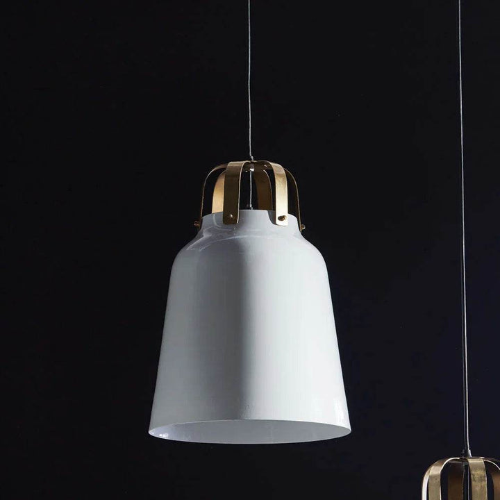 Close-up of brass mount on modern white pendant – dark moody backdrop

