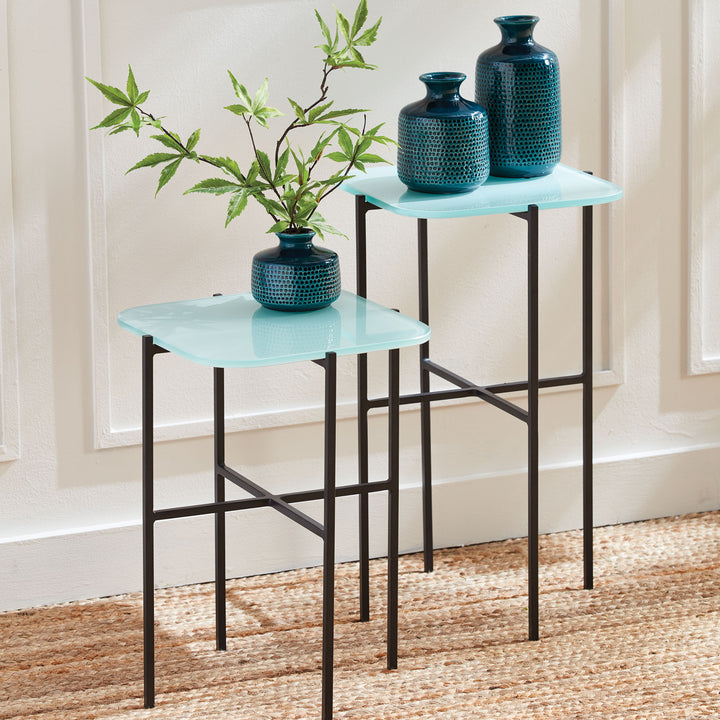 Set of modern minimalist icy blue side tables styled with vases in bright entryway