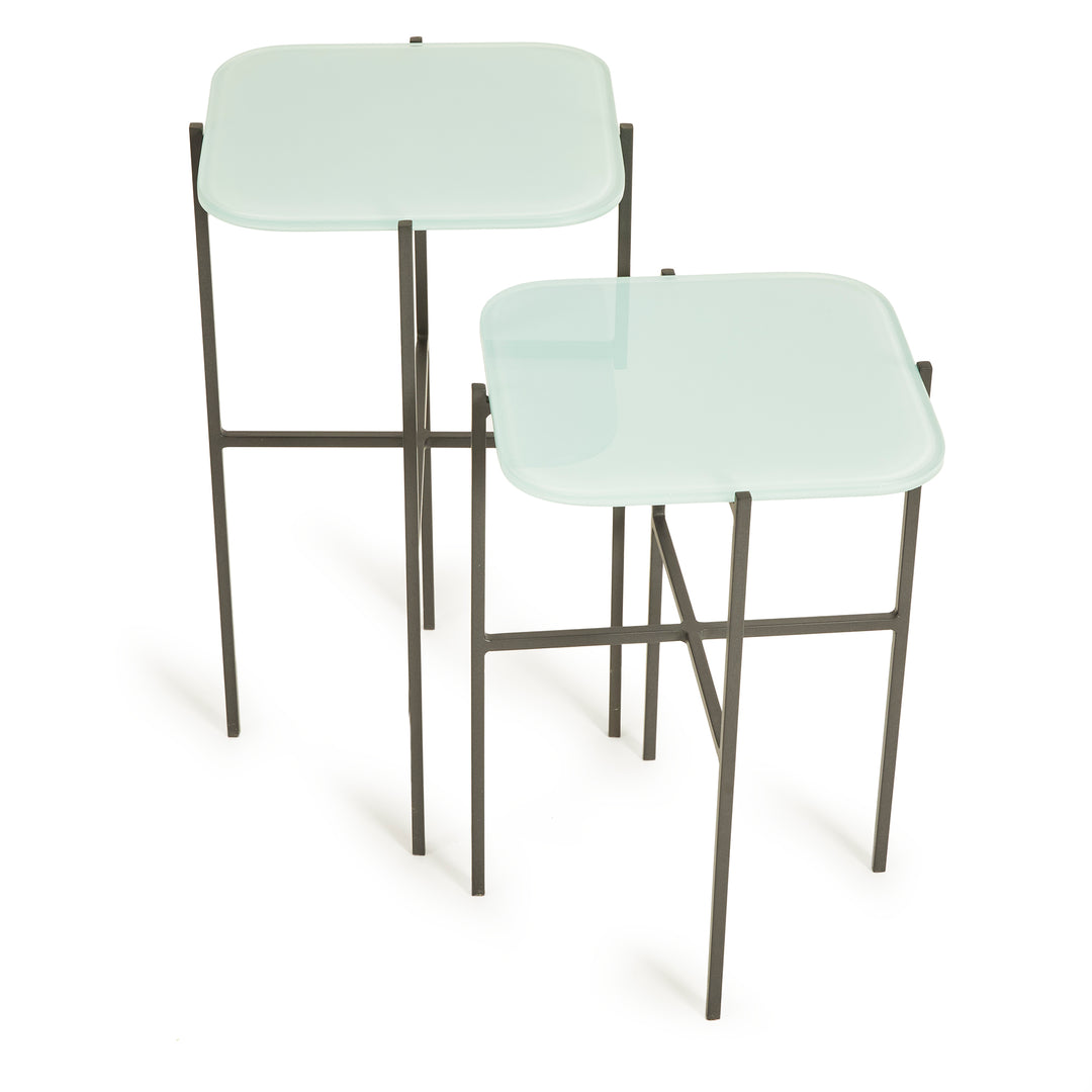 Front view of modern minimalist square side tables with blue glass tops