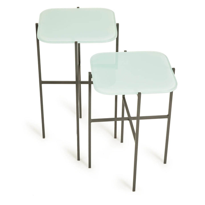 Front view of modern minimalist square side tables with blue glass tops