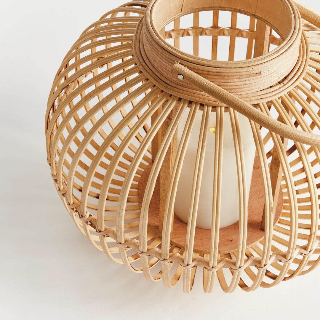 Woven rattan lantern with rounded bamboo handle detail in modern natural coastal boho style

