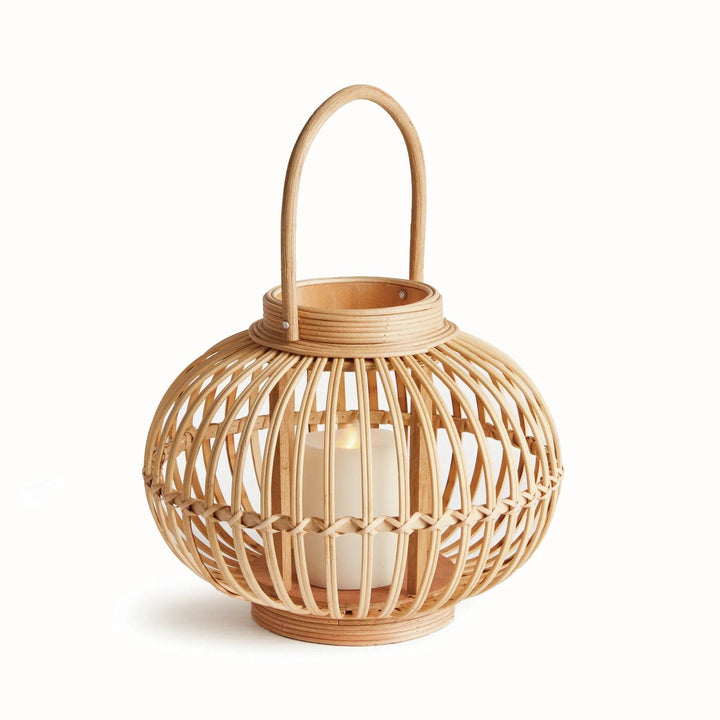Small woven rattan lantern in modern natural style with coastal boho flair and wood base.

