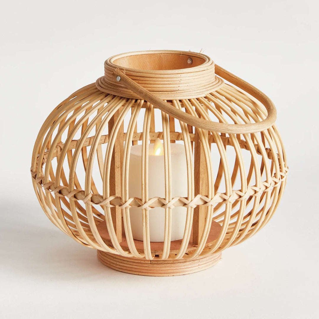 Side view of modern natural rattan lantern small size with LED candle glow and boho accent.

