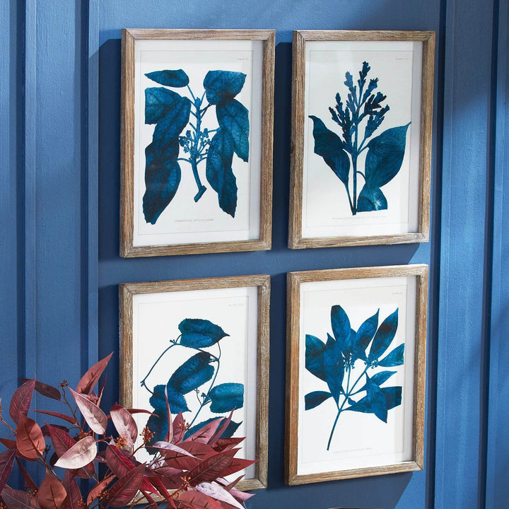 Modern organic wall art set in deep blue styled with red foliage and panelled blue walls
