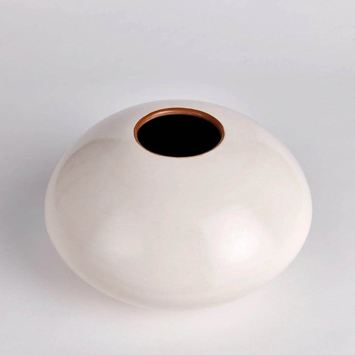 Angled side view of wide round modern organic ceramic vase in soft beige – 13 inch.