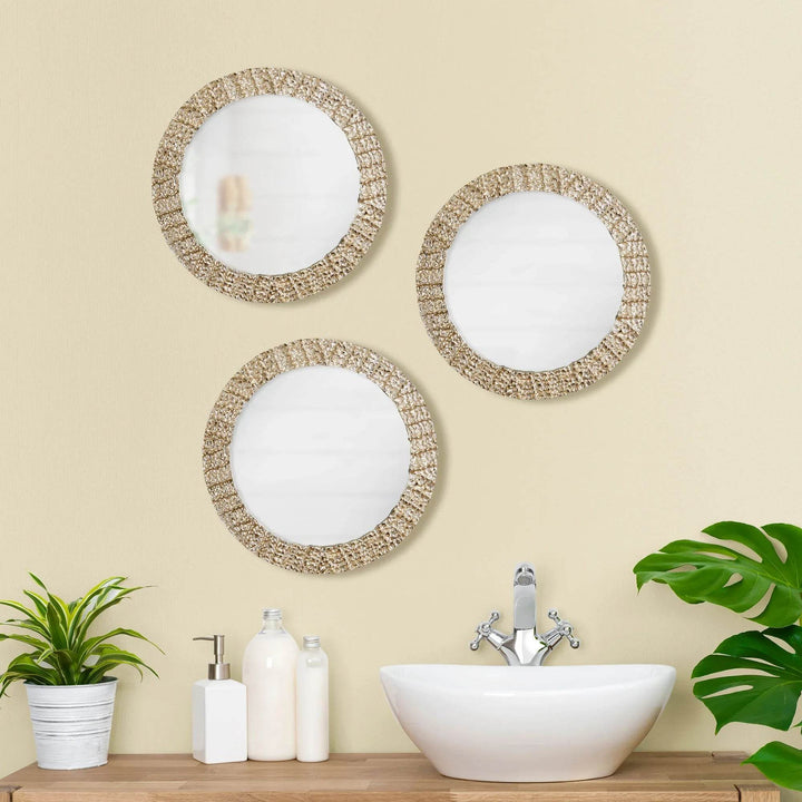 Grouped modern round wall mirrors over bathroom sink with champagne finish and organic styling