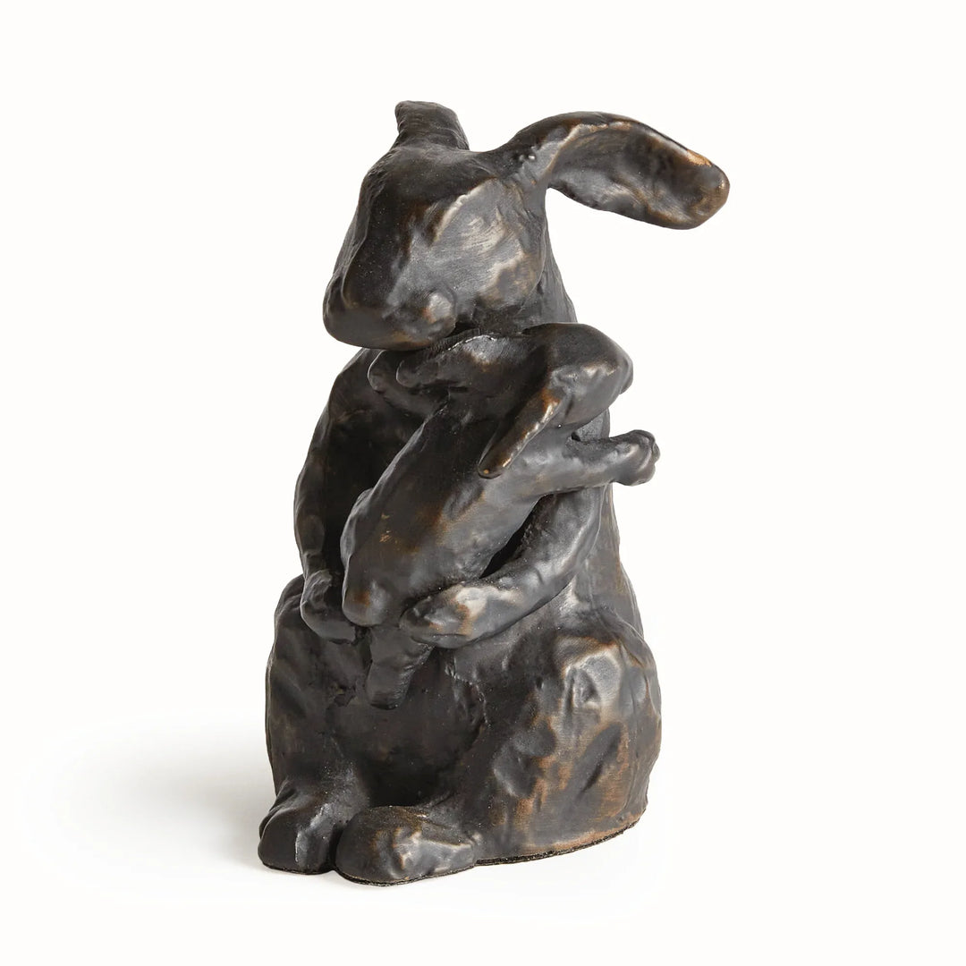 Black mother rabbit sculpture with bronze undertones holding baby, sculpted aluminum tabletop accent with expressive form, rustic decor