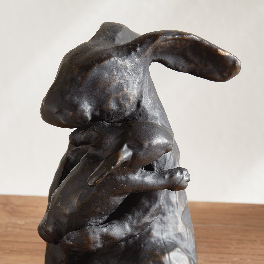 Profile view of mother rabbit sculpture in black with bronze undertones, aluminum decorative animal accent, rustic decor