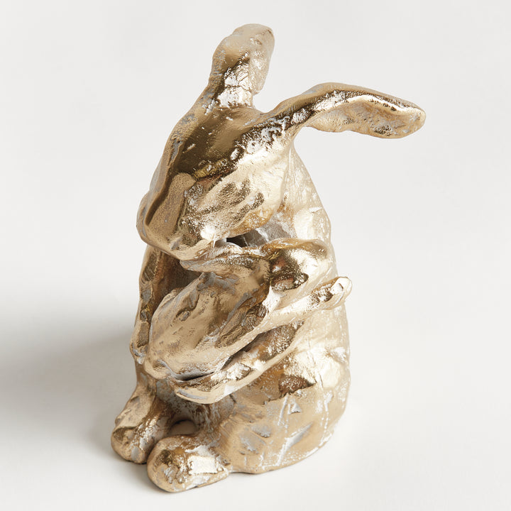 Detail view of mother rabbit sculpture holding baby, white ash gold aluminum surface with organic texture, rustic decor