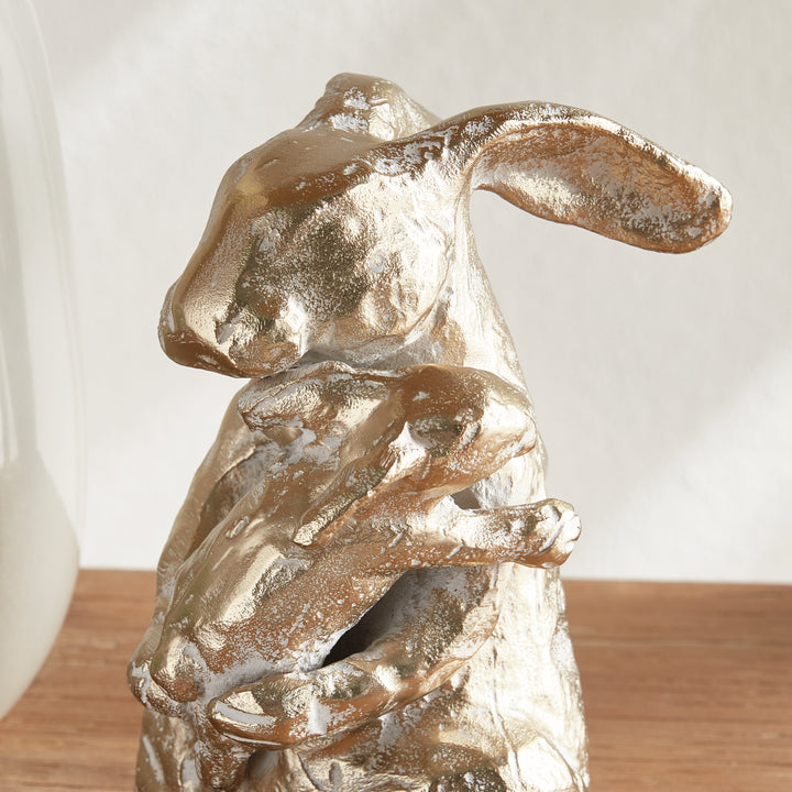 Profile view of gold mother rabbit sculpture holding baby, white ash gold aluminum animal accent, rustic decor