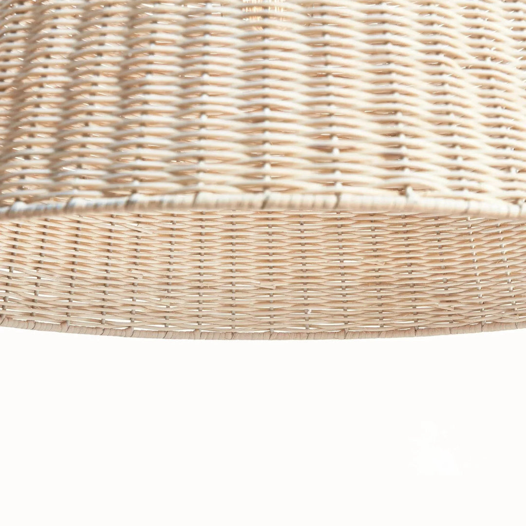 Close-up of natural rattan pendant light showing the handwoven shade, open lower rim and textured natural finish in Coastal