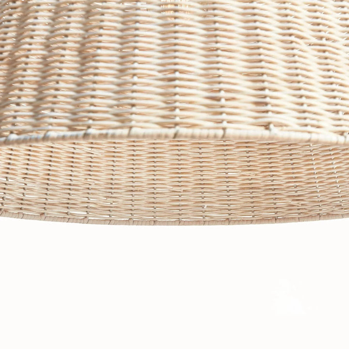 Close-up of natural rattan pendant light showing the handwoven shade, open lower rim and textured natural finish in Coastal