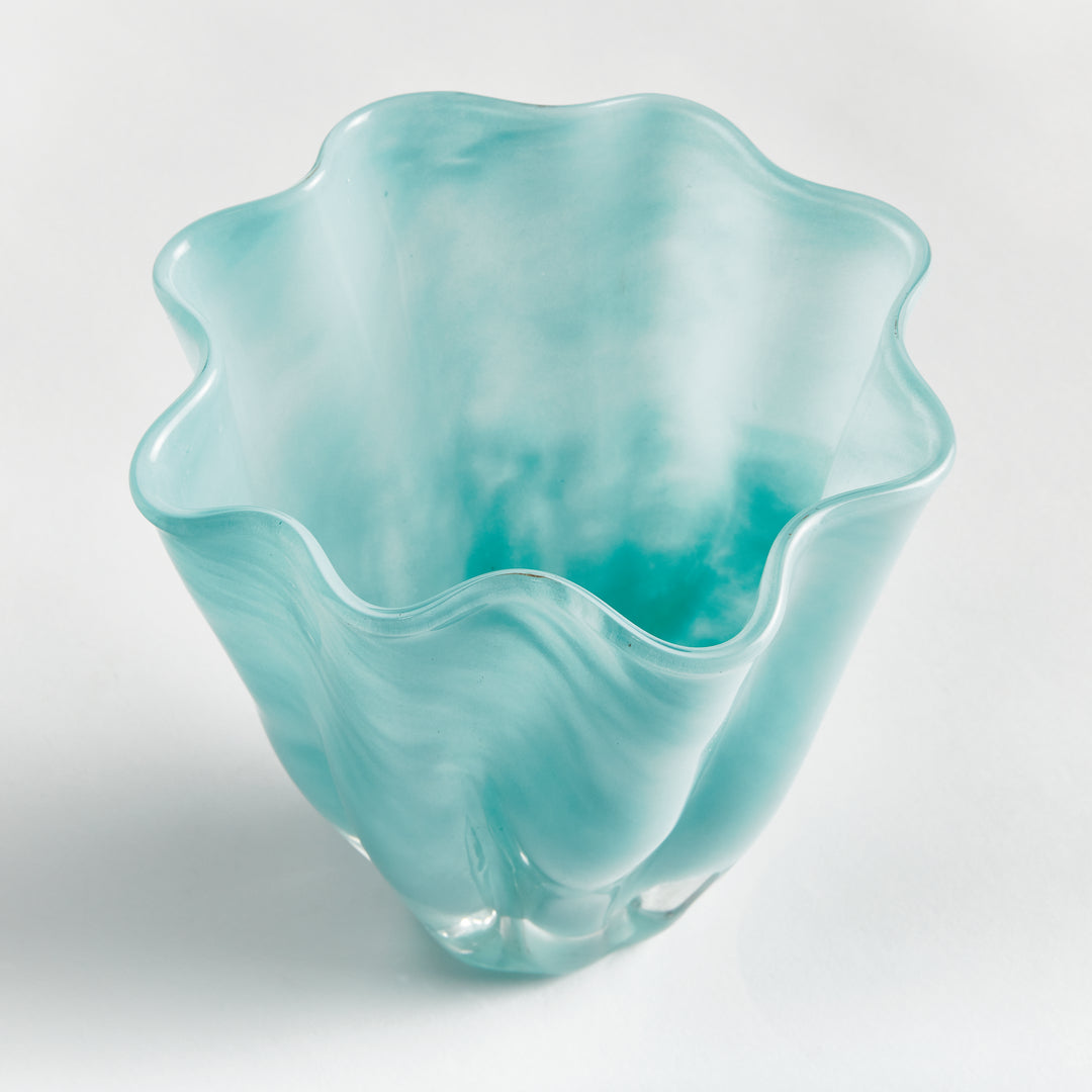 Angled view into a light blue glass vase, showing the wavy rim, mottled interior and solid clear glass base. Relaxed Coastal