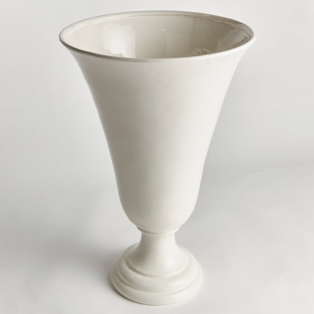 Angled view of a white clay trumpet vase, showing its flared rim, smooth tapered body and raised round foot | Traditional