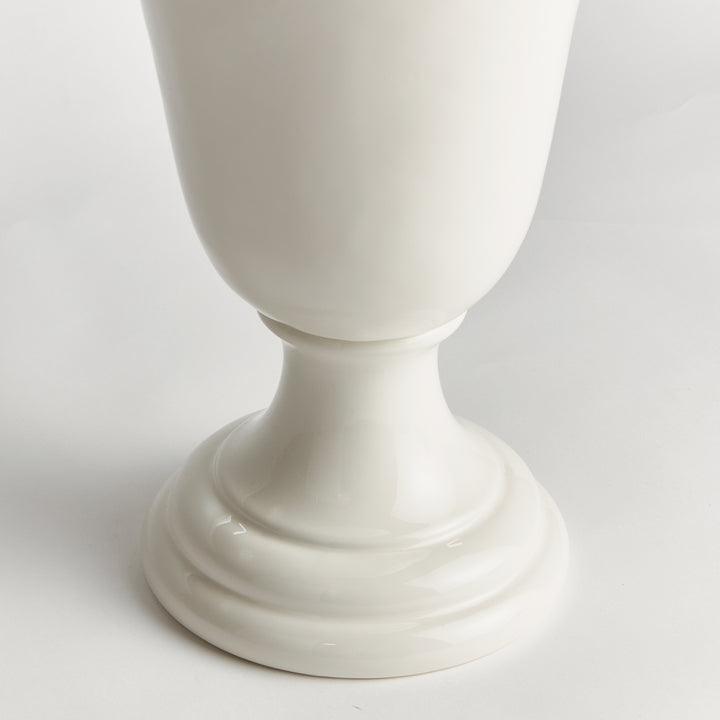 Detail of a white clay trumpet vase showing the narrow lower body, curving pedestal stem and circular foot | Traditional