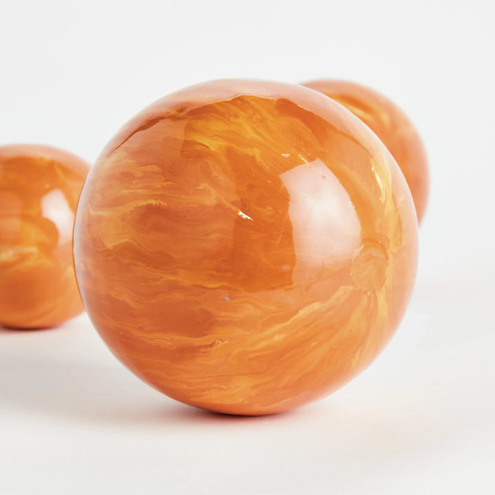 Orange hand painted decorative orb with glossy marbled surface shown angled close detail for shelf styling Modern Organic style