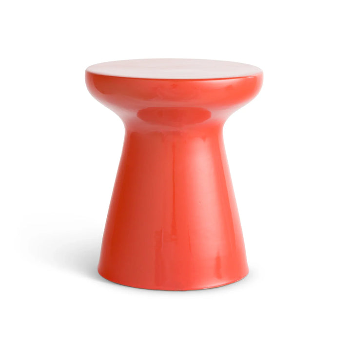 Orange glazed ceramic side table with a round top, narrow neck and flared pedestal base against a pale backdrop, Contemporary