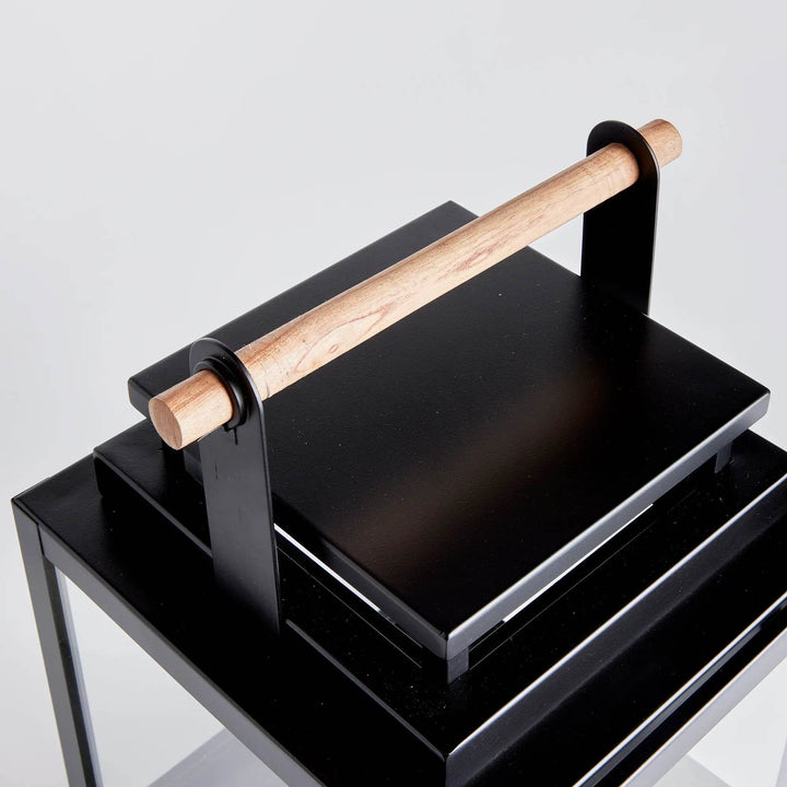 Top view of medium outdoor lantern showing natural teak wood handle and black metal frame