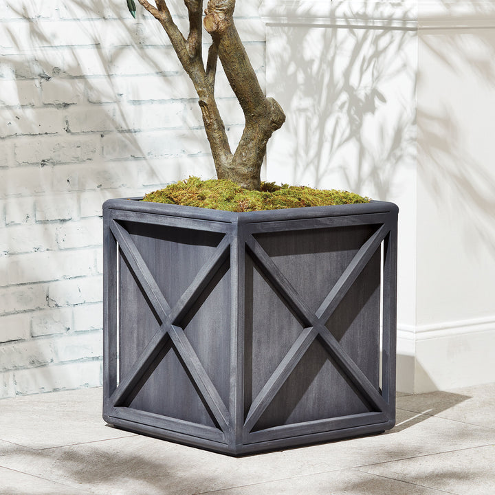 Outdoor metal planter with aged zinc finish styled with greenery in covered patio setting – European Garden planter