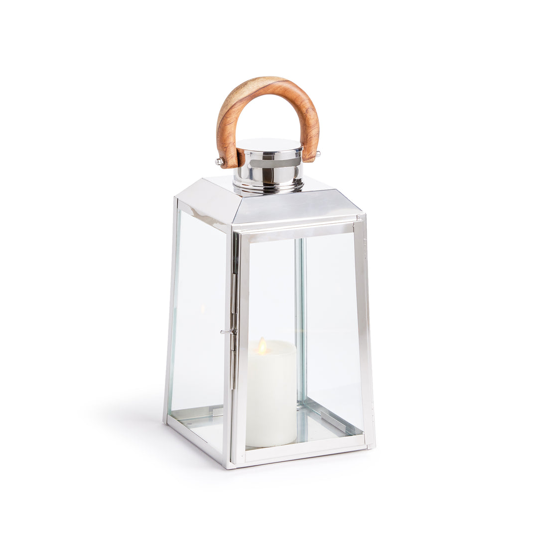 Small outdoor stainless steel lantern with clear glass panels and teak wood handle on white background coastal lantern