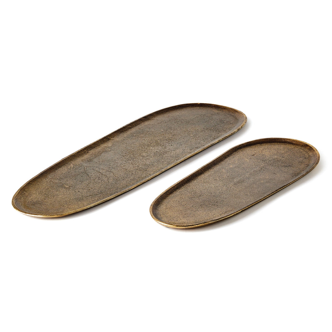 Overhead view of cast aluminum trays in antique brass finish – decorative oval tray set of 2, modern organic.