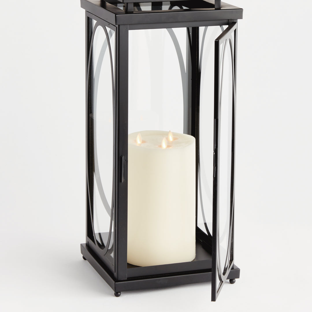 Black oval frame candle lantern with open glass door and flameless candle for architectural interior décor lantern