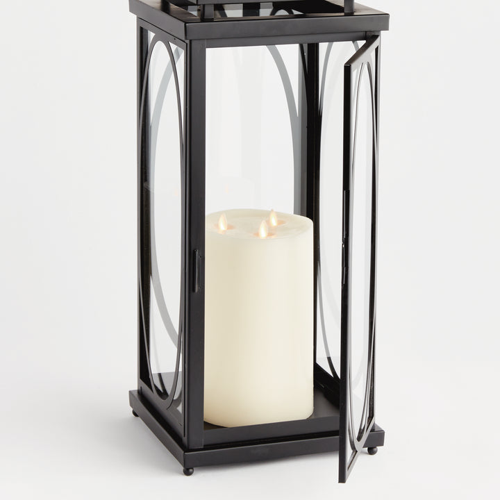 Black oval frame candle lantern with open glass door and flameless candle for architectural interior décor lantern