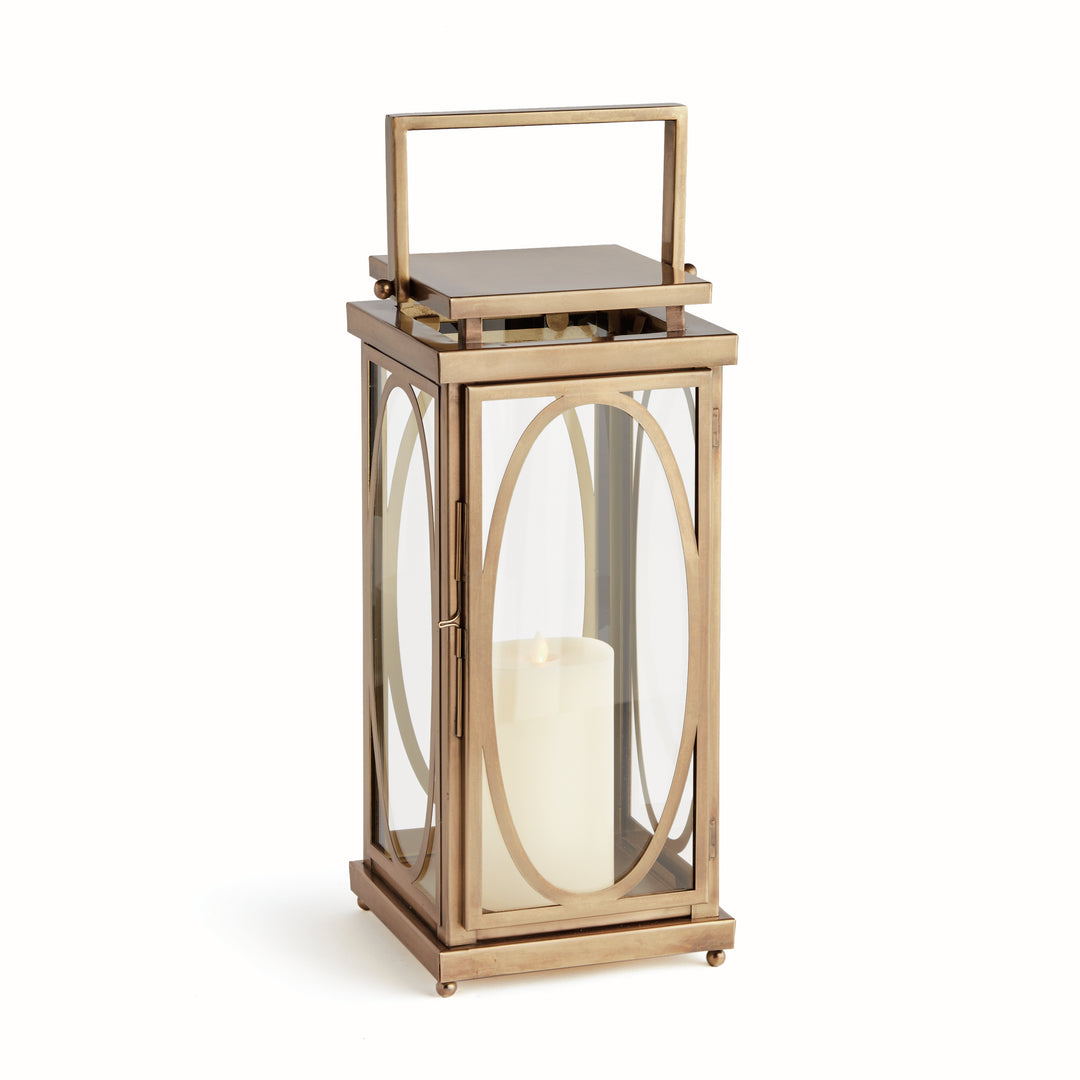 Oval frame candle lantern in warm brass finish with glass panels and flameless candle for transitional interior décor lantern