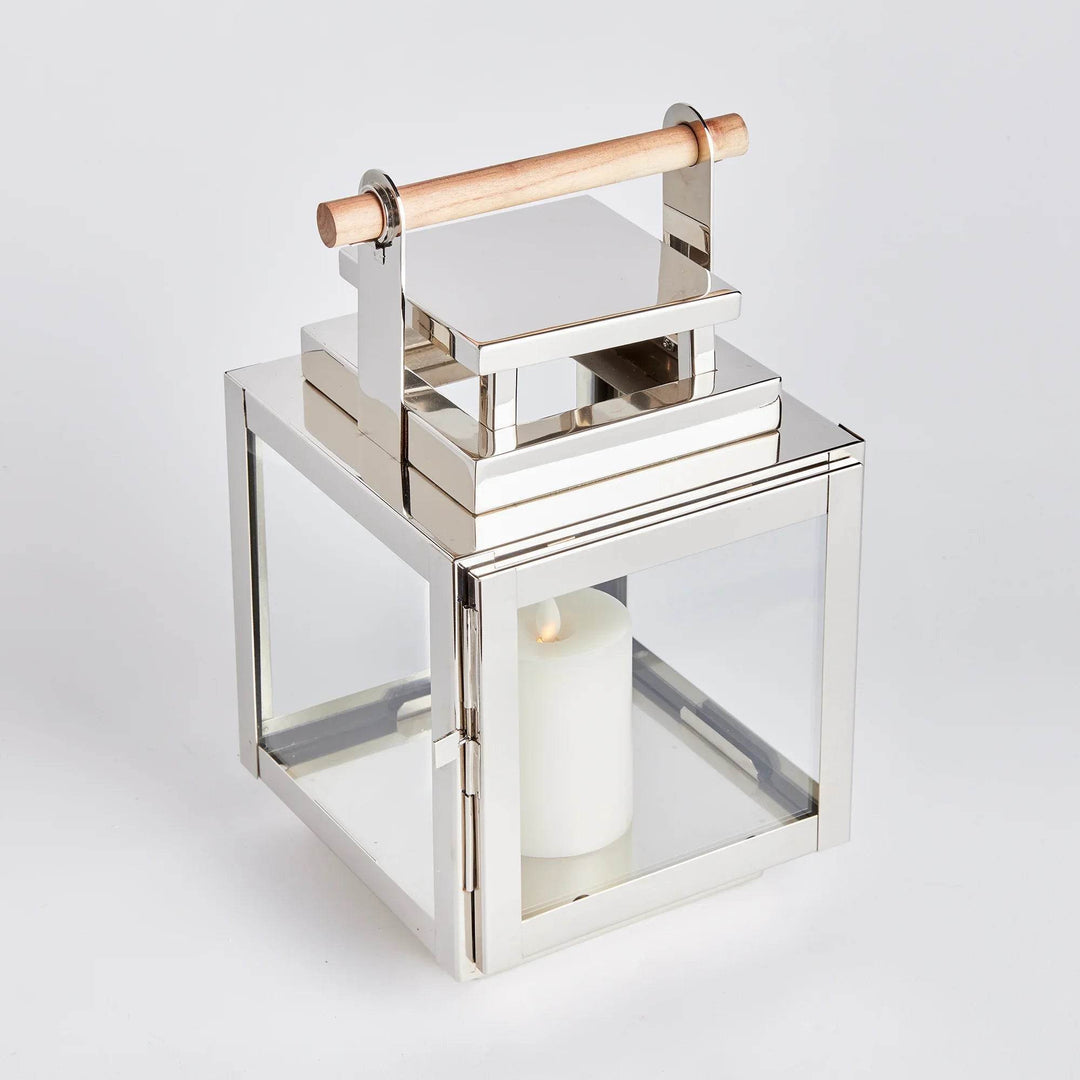 Overhead angled view of small stainless steel lantern with teak handle