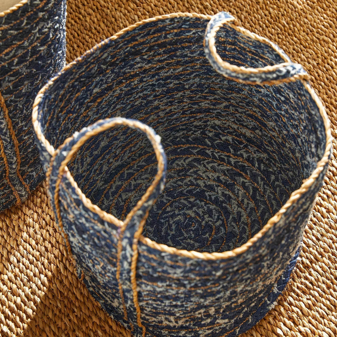 Top-down view of circular blue storage basket showing denim weave pattern and braided rim