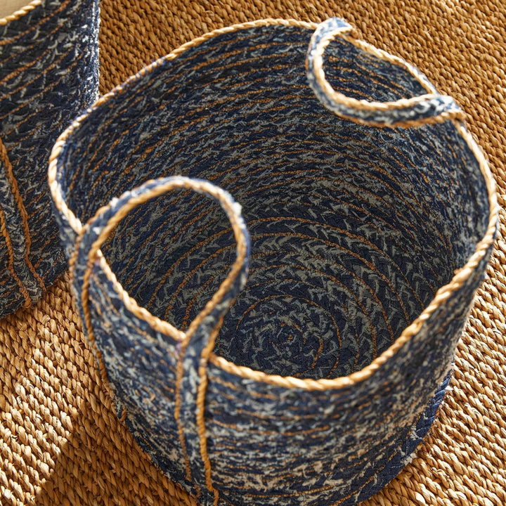 Top-down view of circular blue storage basket showing denim weave pattern and braided rim