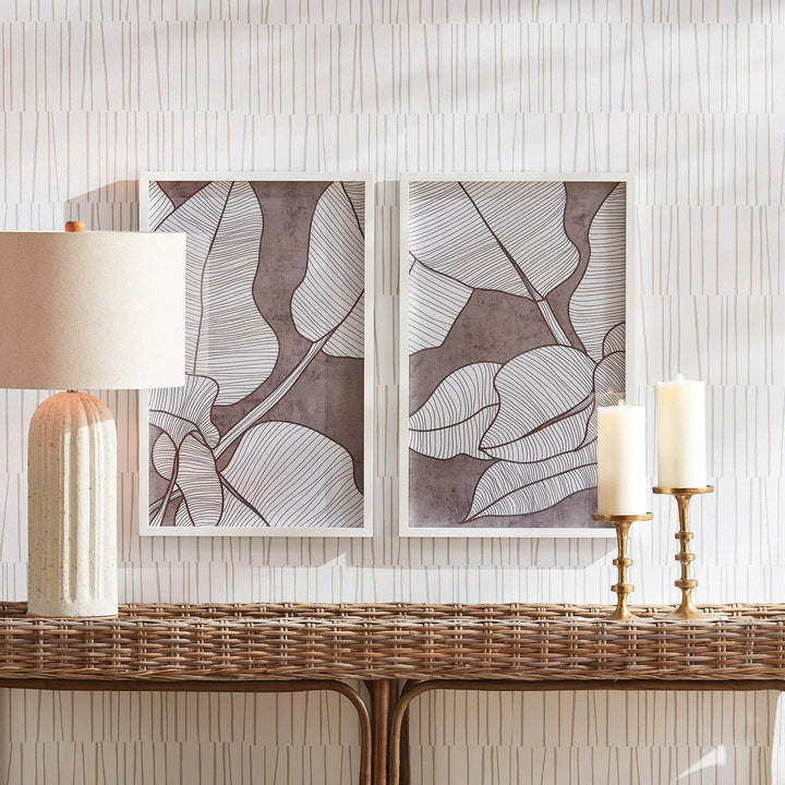 Framed palm prints above rattan console table with neutral lamp and candleholders, styled for a coastal look – Modern Coastal


