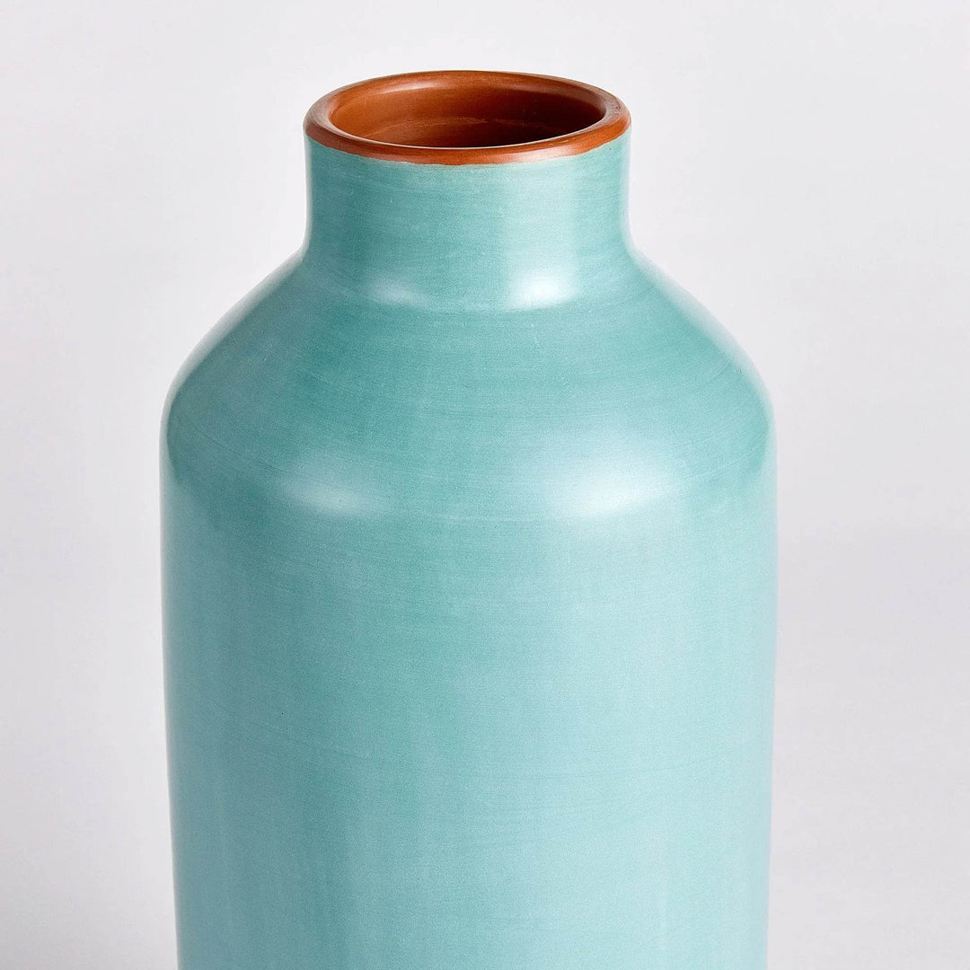 Angled view of pastel blue ceramic bottle vase, artisan-crafted, modern organic styling for home decor

