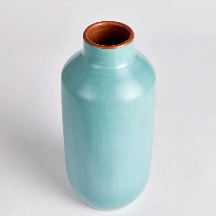 Pastel blue ceramic bottle vase styled with taller blue vase near window, layered modern organic decor

