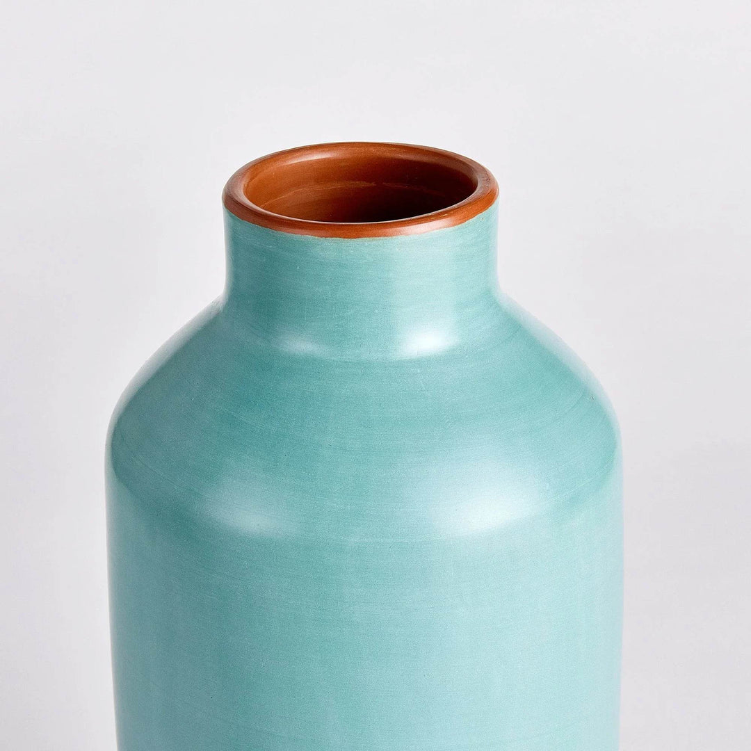 Side view of pastel blue ceramic bottle vase, handcrafted in Peru, showing smooth organic silhouette

