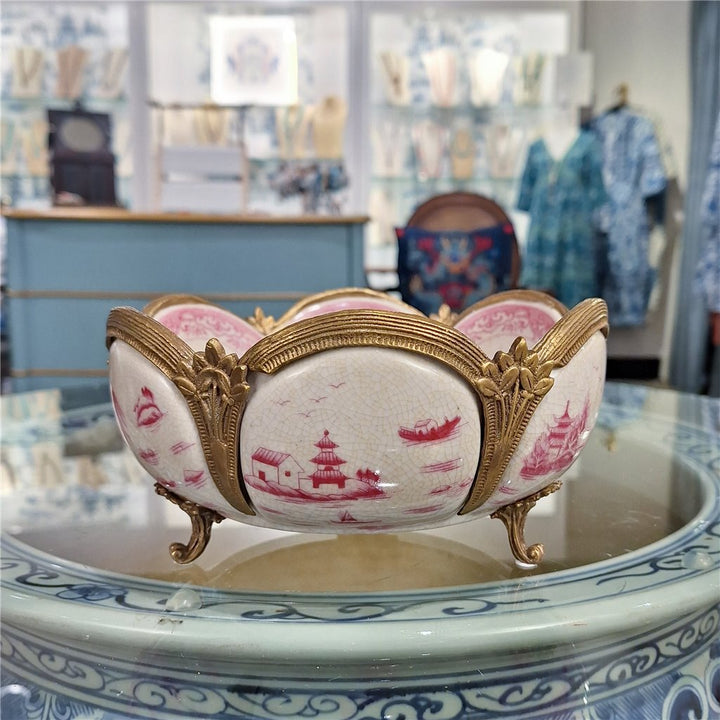 Pink chinoiserie porcelain decorative bowl with bronze ormolu feet styled on tabletop display – Traditional style