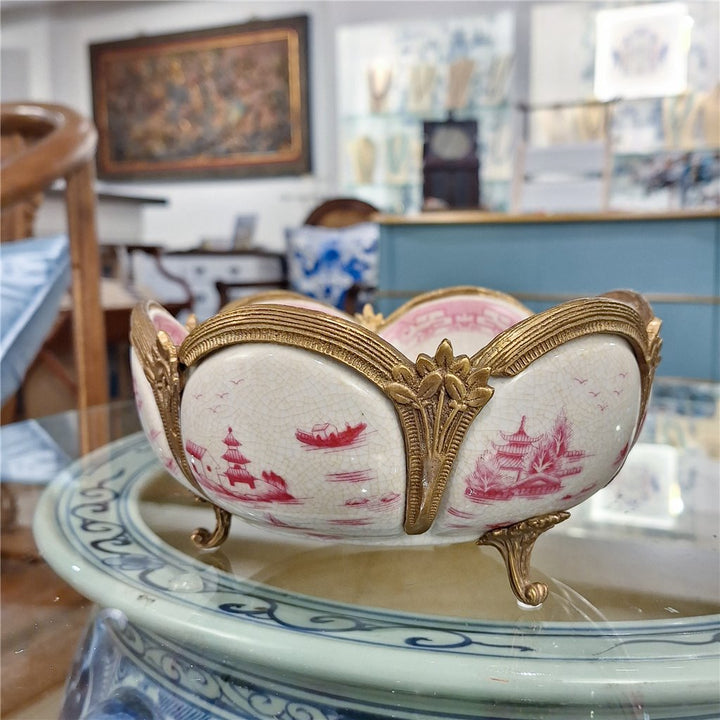 Pink chinoiserie porcelain decorative bowl with bronze ormolu detail displayed in interior setting – Traditional style