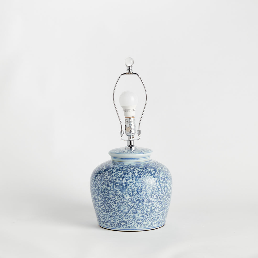 Rear view of porcelain lamp showing floral pattern, clear cord, and lamp structure without the shade – Transitional style.