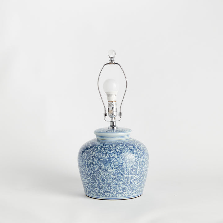 Rear view of porcelain lamp showing floral pattern, clear cord, and lamp structure without the shade – Transitional style.
