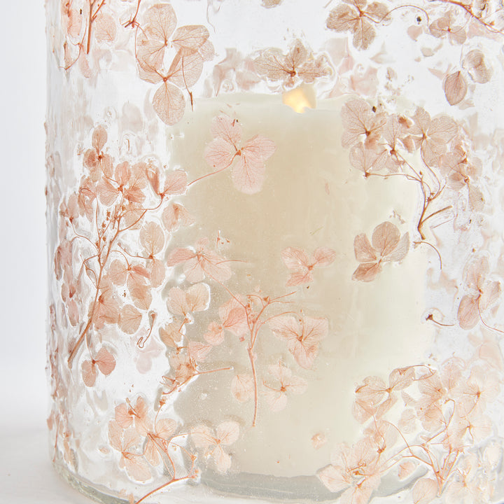 Close detail of clear pink glass hurricane candle holder with preserved petals embedded in textured glass, Romantic Transitional
