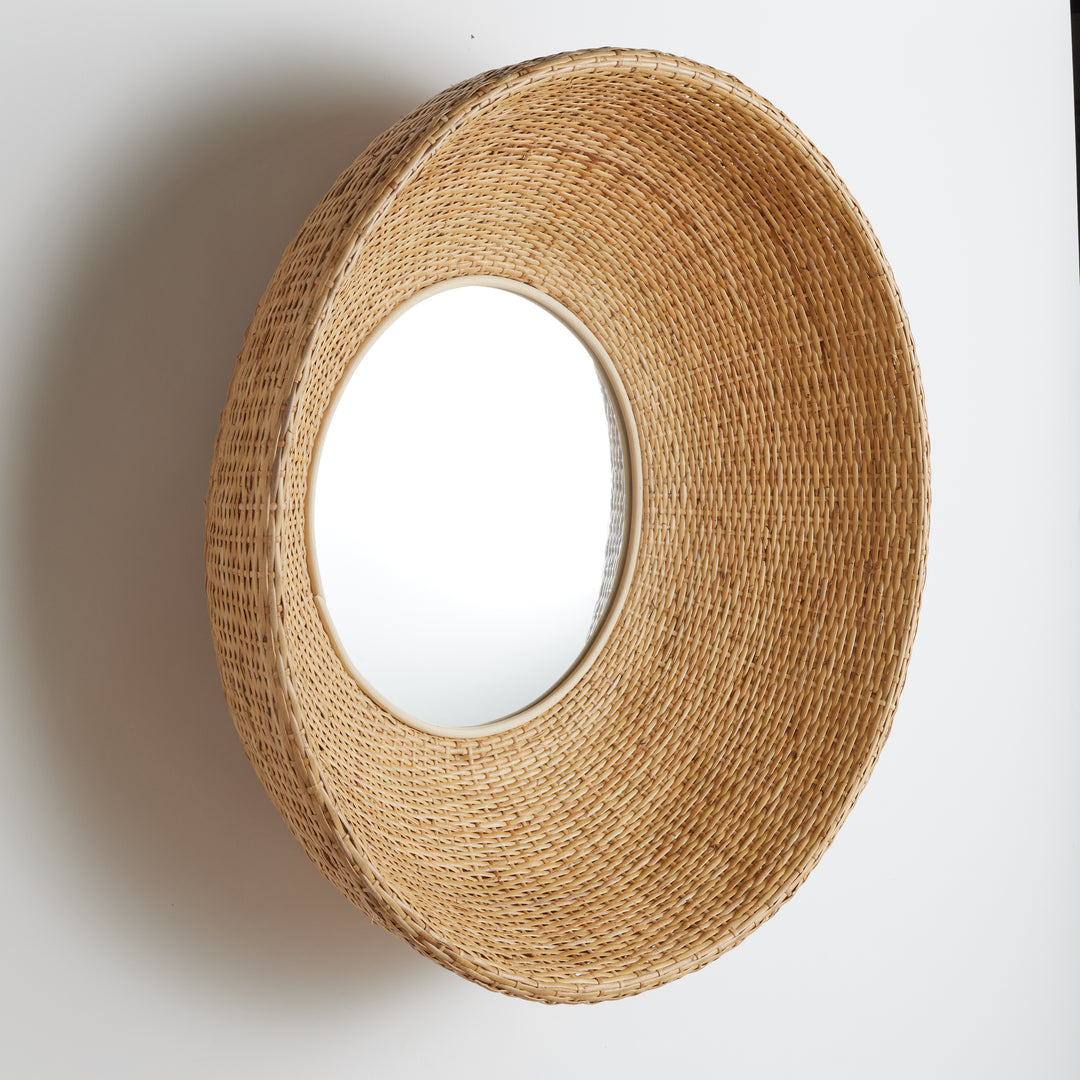 Side profile of sculptural rattan wall mirror showing curved depth and basketweave pattern