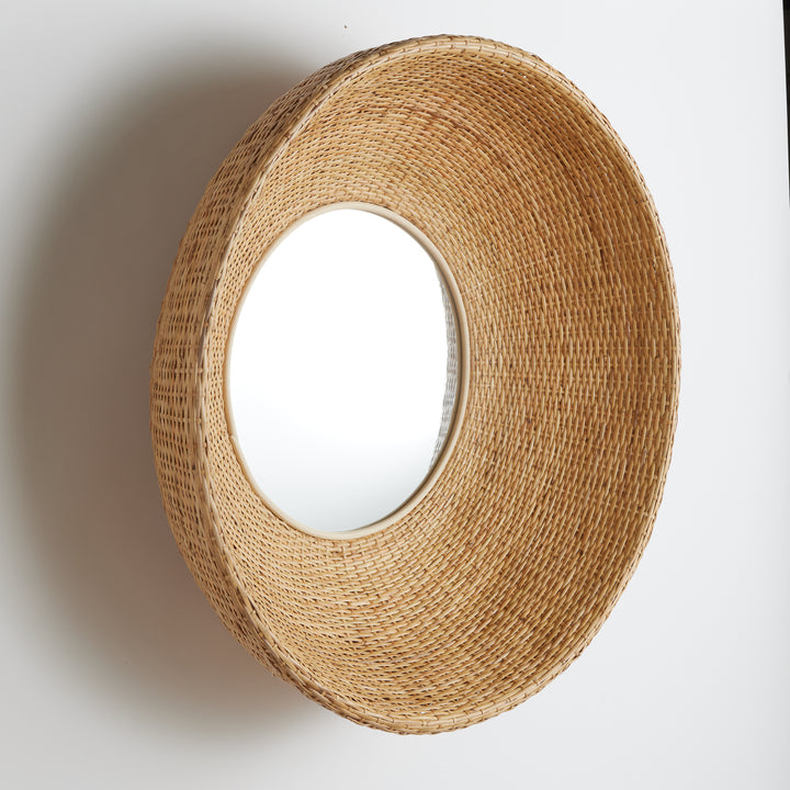 Side profile of sculptural rattan wall mirror showing curved depth and basketweave pattern