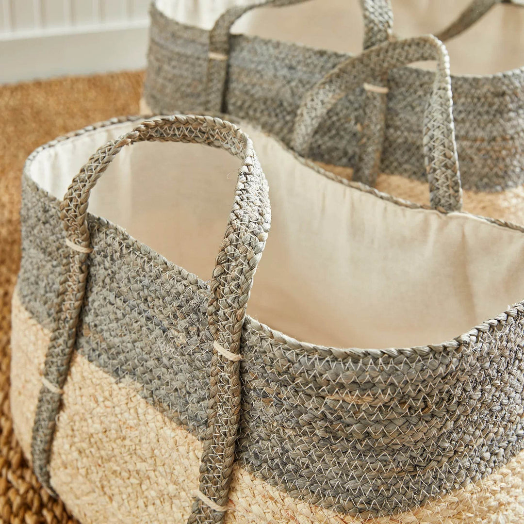 Top view of woven rectangular storage baskets set of two, cotton liners inside gray and natural woven corn husk, indoor storage use.

