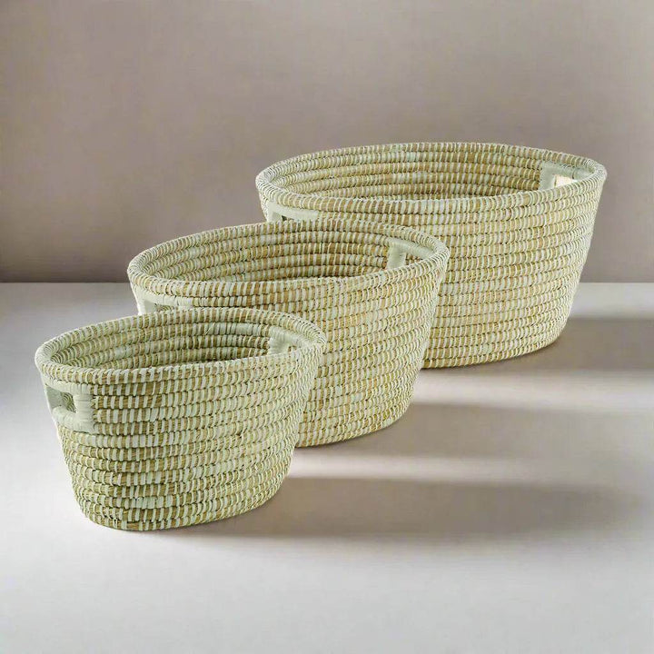 Handwoven rivergrass baskets with built-in handles shown nested, ideal for modern organic home organization.