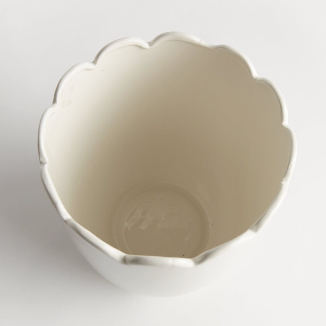 Top view into a white clay cachepot with a scalloped opening and rounded body, shown without a plant insert | Traditional